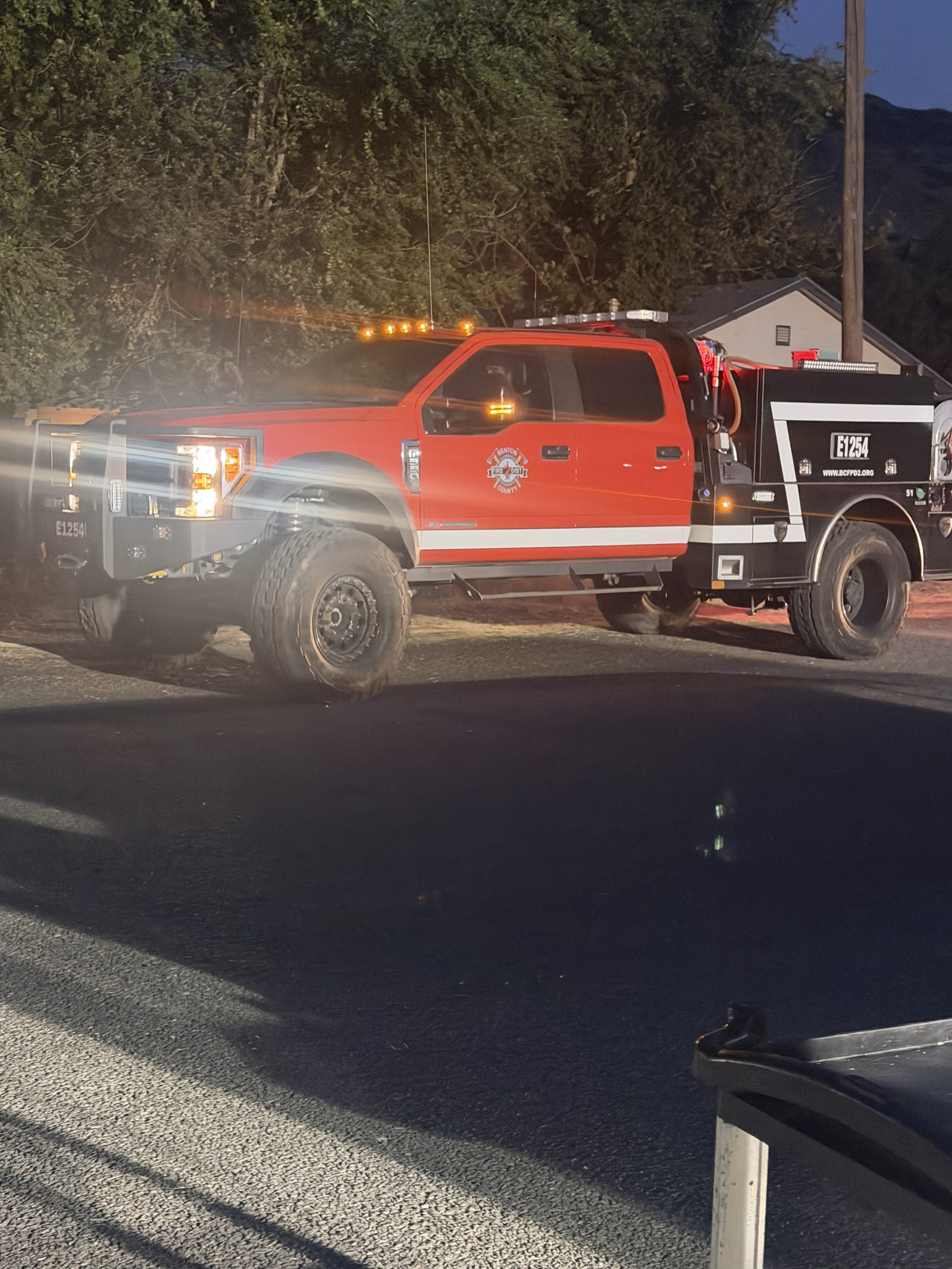 A fire engine staged at dusk during the Lyons Ferry Fire response near Kahlotus, Washington